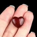 Handheld 15mm heart-shaped red agate polished gemstone with smooth glossy surface - Red Agate