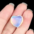 Polished heart-shaped opalite stone with translucent milky blue and yellow fire - Opal (Synthetic)