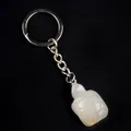 Polished metal keychain featuring a white translucent crystal turtle pendant on black background - Natural Agate