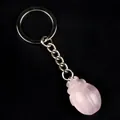 Pink quartz crystal carved pig keychain with silver metal ring on black background - Rose Quartz