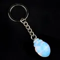 Beetle-shaped keychain with translucent opalite gemstone pendant on black background - Opal (Synthetic)