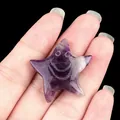 Handheld natural purple crystal starfish figurine with carved smiley face design - Amethyst