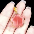 Pink semi-precious quartz flower pendant with golden plating held in hand - Watermelon Red (Synthetic)