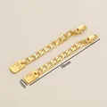 Close-up of 18K gold-plated extension chain with lobster clasp and engraved name tag - 7x78mm