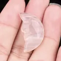 Hand holding a 25mm hand-carved pink crystal moon face stone for DIY candle crafts - Agate