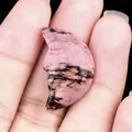 Carved rhodonite crystal man in the moon stone in natural pink and black tones - Rhodonite