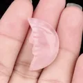 Hand holding a 25mm rose quartz carved crescent moon with a human face profile - Rose Quartz