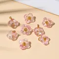 Detail of eight transparent pink glass flower pendants with gold bead accents for DIY jewelry - 10x10mm / Pearl Light Pink