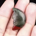 Green and red bloodstone carved moon face pendant held in hand for scale - African Blood Stone