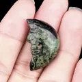 Hand-carved Kambaba Jasper crescent moon stone with man-in-the-moon face detail - Rhyolite