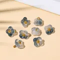 Translucent smoke grey glass flower pendant with golden center and metal loop - 10x10mm / Ink Blue