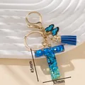 Portachiavi lettera T in resina blu con paillettes, nappa e chiusura dorata - Blu T