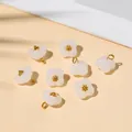 Eight white translucent four-petal flower charms with golden metal core and hanging loops - 10x10mm / White