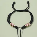Handgefertigtes schwarzes Webarmband mit rosa und goldenen Blumenknoten für DIY-Schmuck - Schwarz