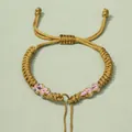 Handgefertigtes gewebtes Armband mit goldener und rosa Kordel und Schiebeverschluss - Erdgelb
