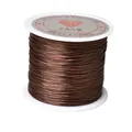 Macro detail of dark brown strong elastic crystal string on a white plastic spool - Standard Roll / Coffee
