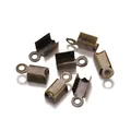 Macro shot of bronze fold-over cord crimp ends for DIY jewelry making accessories - 3*6mm / Antique Bronze