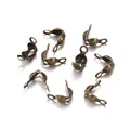 Macro shot of antique bronze jewelry clam shell bead tips with dual connector loops - 4x7mm / Antique Bronze