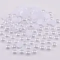 Macro shot of white half-round flatback pearls with lustrous finish for DIY crafts - 2mm / White