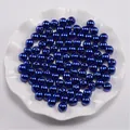 Macro-opname van marineblauwe ronde ABS-parels met gaten voor doe-het-zelf sieraden - Blauw