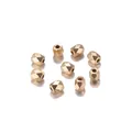 Macro shot of 9 gold faceted geometric beads with center holes for DIY jewelry making - 3MM (500 Pieces/Pack) / KC Gold