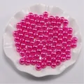 Detailopname van roze ABS imitatieparels met gaten voor DIY-sieraden maken - Rozerood