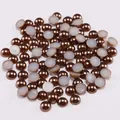 Close-up of bronze ABS flatback half pearls for DIY crafts and nail art accessories - Coffee