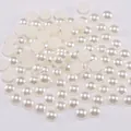 Detailed view of loose creamy white flatback ABS half pearls for DIY crafts and nail art - 2mm (10000 Pieces/Pack) / Off White