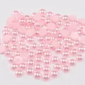 Macro view of pink half-round ABS flatback pearls with lustrous finish for DIY crafts - Light Pink