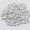 Close-up of bulk flatback white ABS faux pearls for DIY nail art and clothing decor - Light Gray
