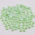 Detailed view of light green flatback ABS pearls with a pearl luster for jewelry DIY - Light Green