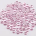 Detailed macro view of light pink half-round ABS imitation pearls with smooth glossy finish - Light Purple