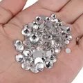 Sparkling white round faceted rhinestones with silver backing held in a person's palm - 1.2mm SS3 (1440 Pieces/Pack) / Silver (Crystal Clear)