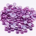 Macro shot of purple pearlescent flatback half round ABS pearls for DIY nail art and crafts - Purple