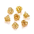Macro detail of golden crown-shaped metal bead caps and flower spacers for DIY jewelry - 5x6 / Gold