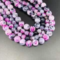 Vibrant multi-color fire agate round beads with natural patterns in purple and black - Red