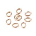Macro shot of gold-plated oval open jump rings for DIY necklace and bracelet jewelry making - 4*3mm (300 Pcs/Pack) / KC Gold