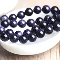 Polished blue goldstone beads bracelet with shimmering sparkles on white ceramic bowl - Mini / Dark Blue