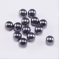 Close-up of metallic dark grey ABS imitation pearls with smooth reflective surface - 10mm (500g/Pack) / Gray