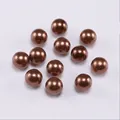 Macro shot of smooth dark brown pearlescent ABS beads for DIY jewelry making - Coffee