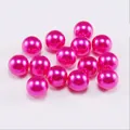 Close-up of vibrant pink round imitation pearls with glossy finish for DIY jewelry crafts - Rose Red