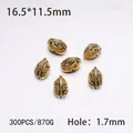 Macro view of gold Spartan helmet metal beads with 16.5x11.5mm size for jewelry DIY - 300PCS/Pack / Golden Helmet