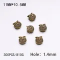 Detailed macro view of 11mm antique bronze owl spacer beads for DIY jewelry making - 300PCS/Pack / Gold Owl