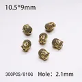 Detail view of antique gold Buddha head beads for jewelry making with 10.5x9mm dimensions - 300PCS/Pack / Gold Big Ear Buddha