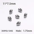 Close-up of 11x7.5mm silver skull beads for DIY jewelry with 1.75mm hole size - 300PCS/Pack / Silver Belt Skull Buckle