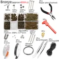 Detailed macro view of bronze DIY jewelry kit with pliers, tweezers, and 800 metal findings - Bronze
