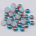 Macro shot of colorful gradient semi-round resin pearls for DIY phone case crafts - Teal