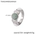 Retro-Ring aus vergoldetem Edelstahl mit Türkisstein und weißen ovalen Akzenten - US 6 / Stahlfarbener Ring