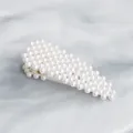 Classic drop-shaped hair clip with white pearls and white metal base on marble surface - White Pearl Waterdrop Style (HS-J5867)