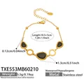 Goldenes Edelstahl-Armband mit schwarzen Katzenaugen-Steinen und hohlen Ringen - Armband / 18.5+5cm / Gold Schwarz